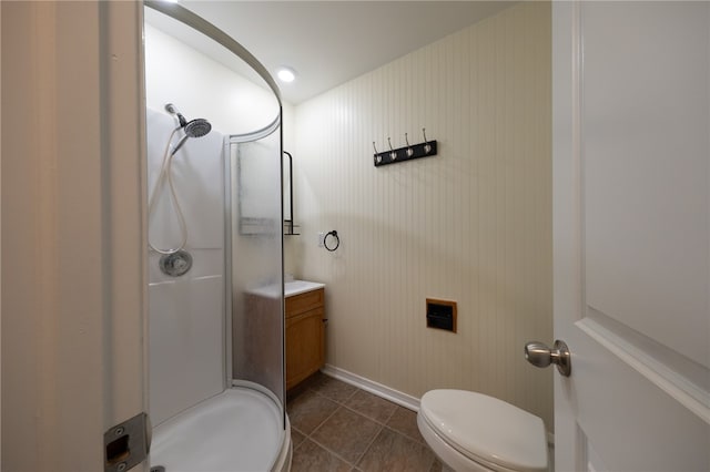 bathroom with toilet, vanity, tile patterned floors, and walk in shower