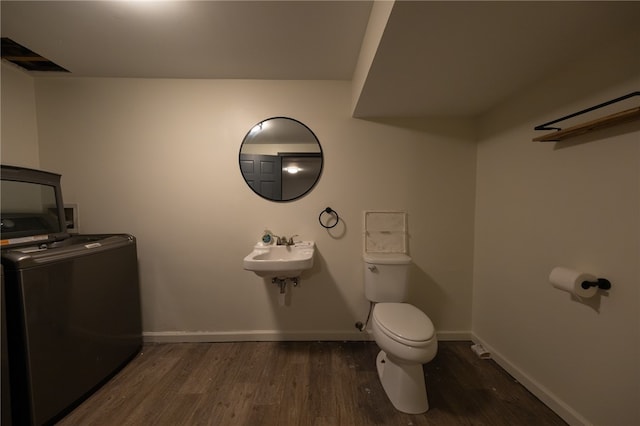 bathroom with hardwood / wood-style flooring, toilet, and sink