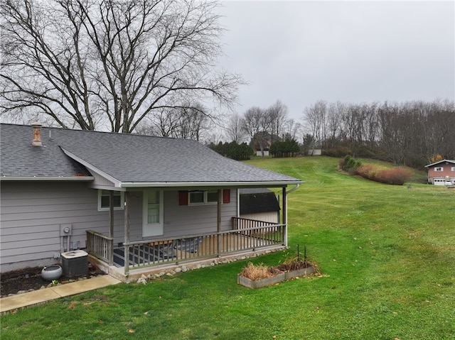 exterior space with a lawn and central AC