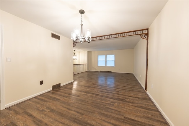 unfurnished dining area featuring a chandelier and dark hardwood / wood-style floors