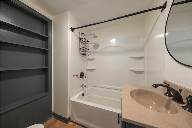 bathroom featuring hardwood / wood-style floors, vanity, and shower / bathing tub combination