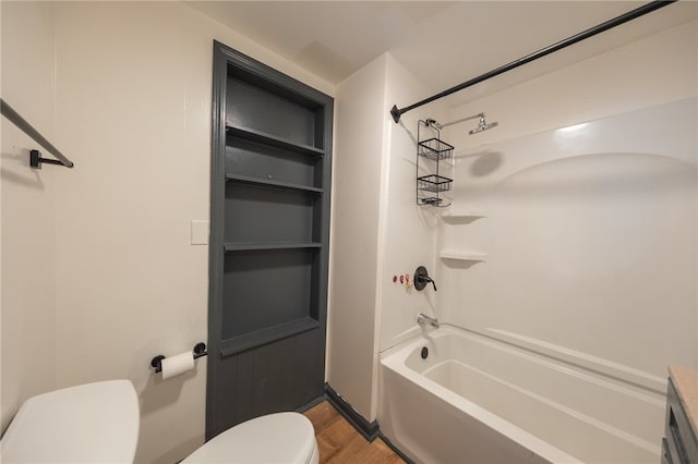 bathroom with shower / bathing tub combination, toilet, and wood-type flooring