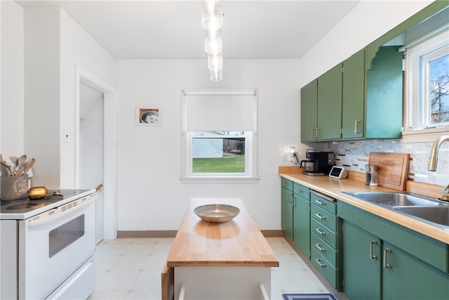 kitchen featuring green cabinets, white range, and sink