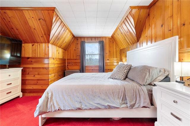 carpeted bedroom featuring wood walls and vaulted ceiling