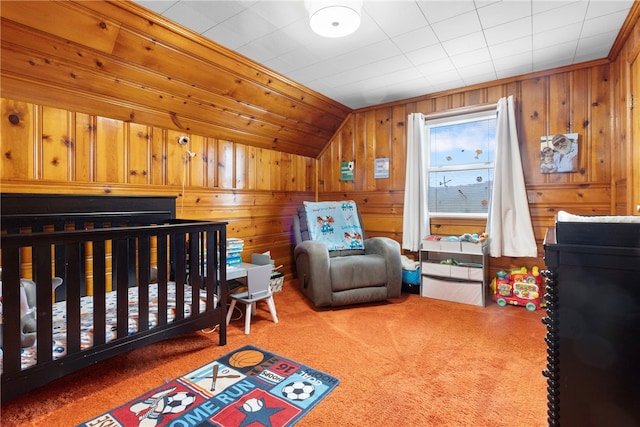 bedroom featuring a crib, carpet floors, lofted ceiling, and wood walls