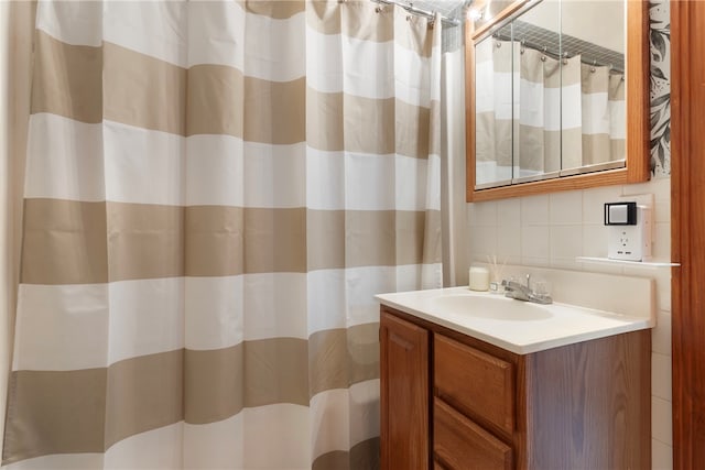 bathroom with vanity, tasteful backsplash, and curtained shower