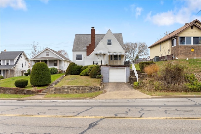 view of front of home featuring a garage and central air condition unit