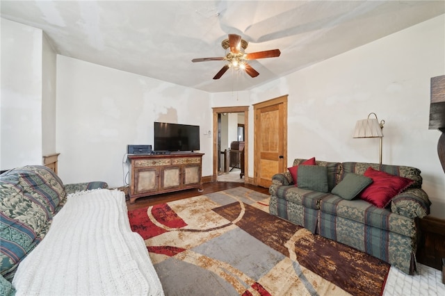 living room featuring ceiling fan and wood-type flooring