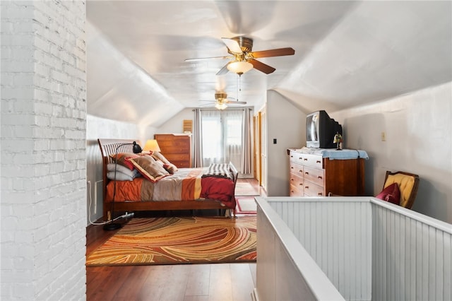 bedroom with ceiling fan, wood-type flooring, and lofted ceiling