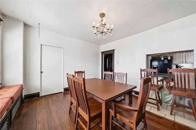 dining space featuring a notable chandelier and dark hardwood / wood-style flooring