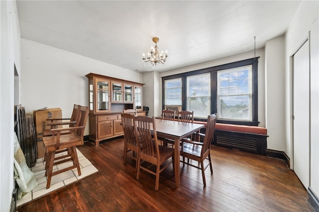 dining space featuring a chandelier and dark wood-type flooring