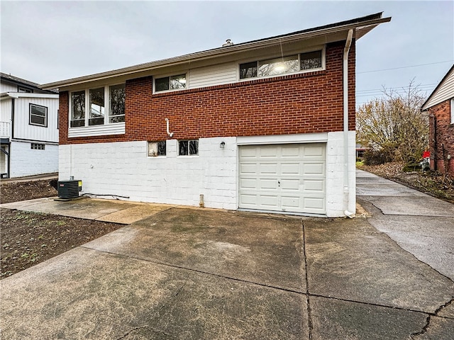 exterior space featuring cooling unit and a garage