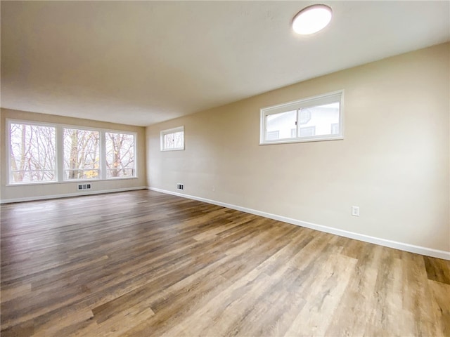 unfurnished room with hardwood / wood-style flooring