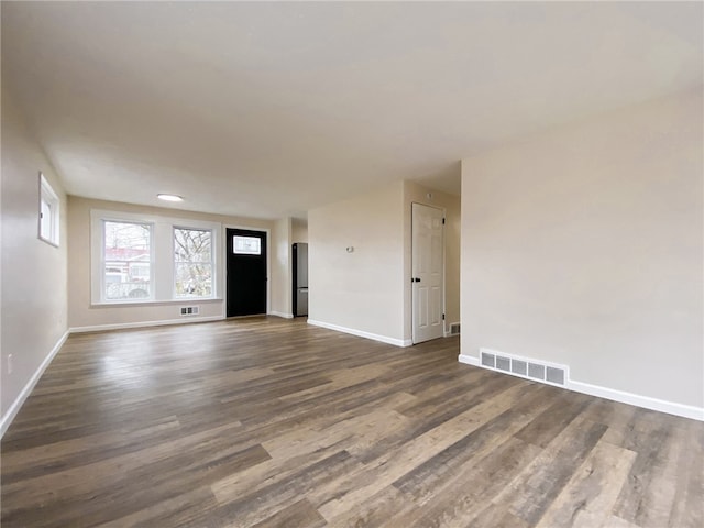 empty room featuring dark hardwood / wood-style flooring