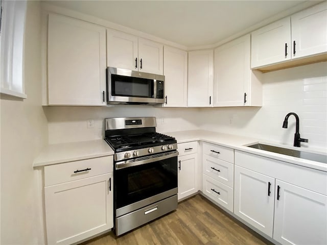 kitchen featuring white cabinets, dark hardwood / wood-style floors, sink, and stainless steel appliances