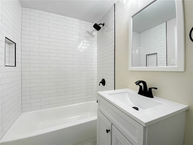 bathroom with vanity and tiled shower / bath combo