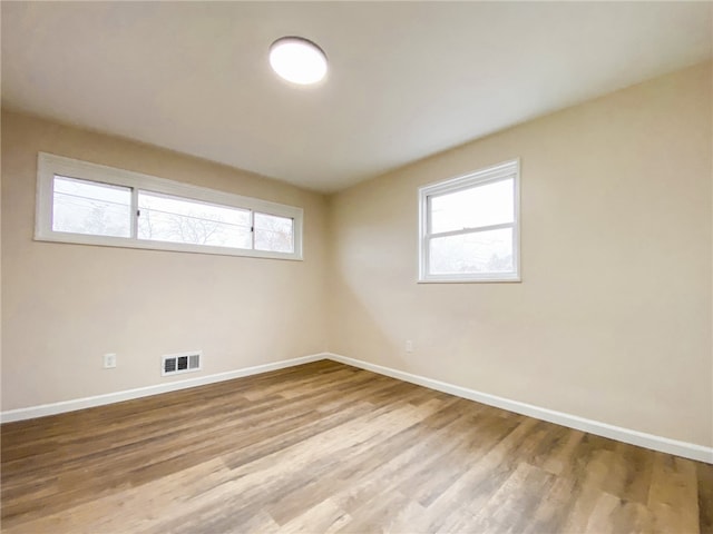 spare room featuring light hardwood / wood-style flooring