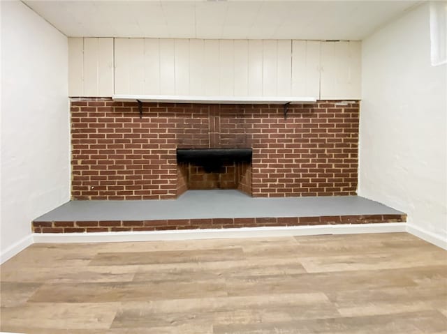 interior details featuring a fireplace and hardwood / wood-style flooring