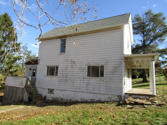 view of side of home with a lawn