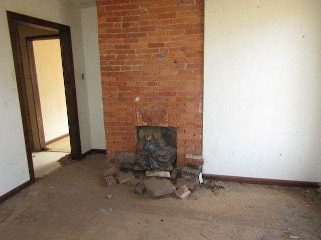 unfurnished living room with a brick fireplace