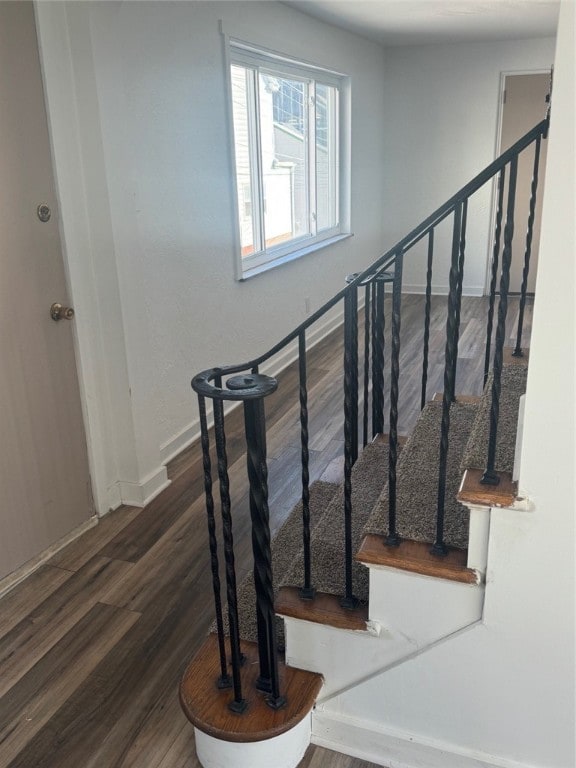 stairs featuring hardwood / wood-style floors