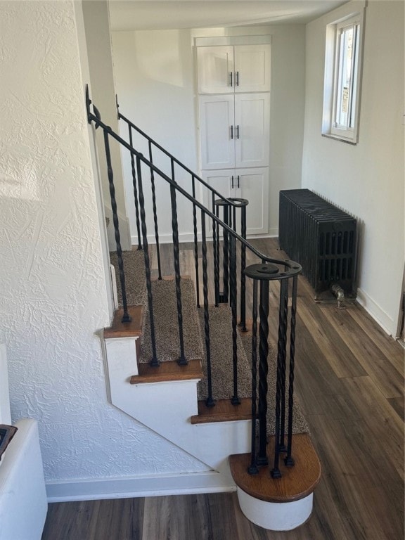 stairs featuring wood-type flooring