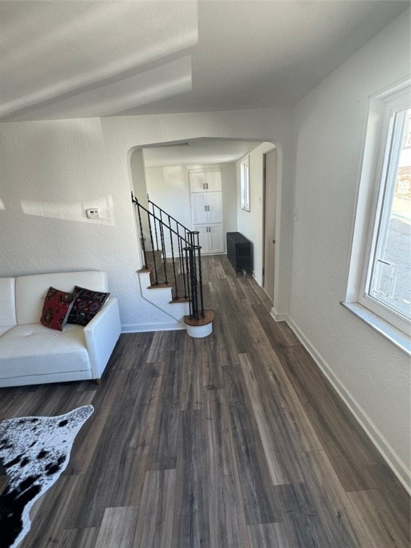 hall with dark hardwood / wood-style flooring and vaulted ceiling