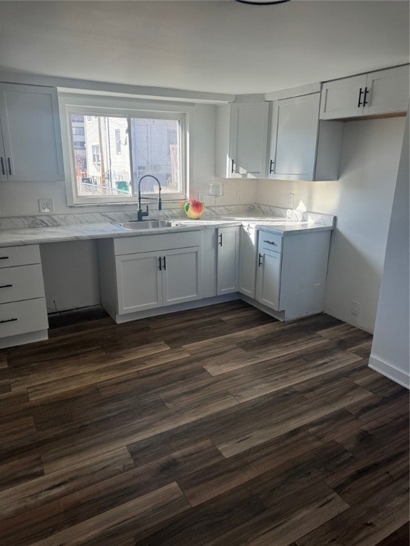 kitchen featuring white cabinetry and dark wood-type flooring