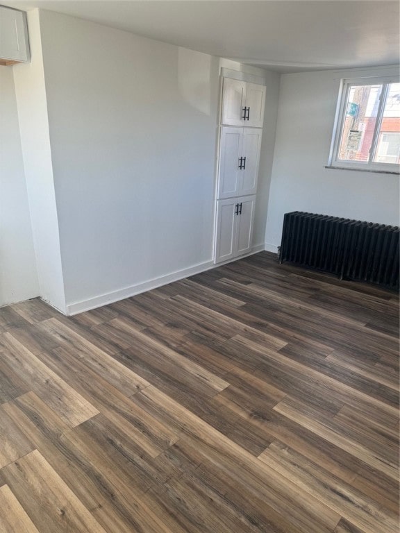 empty room with dark wood-type flooring