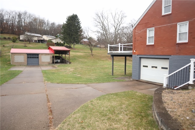 view of yard with a garage and a wooden deck