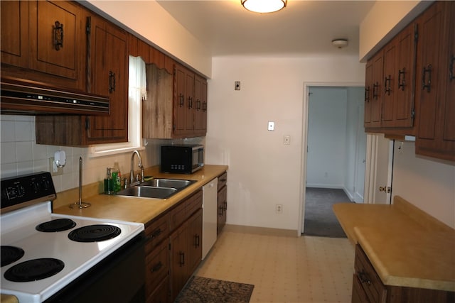 kitchen with decorative backsplash, white appliances, sink, and extractor fan