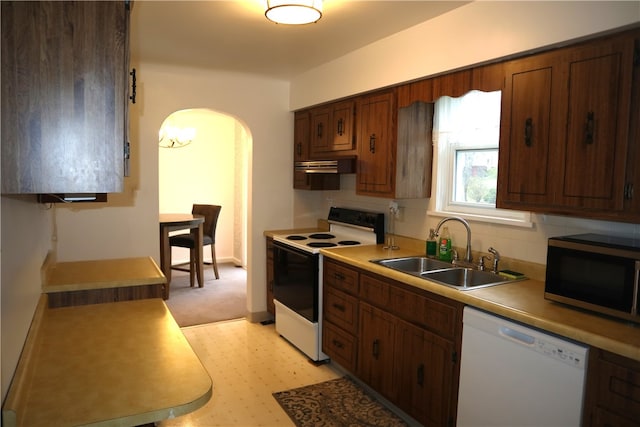 kitchen featuring white appliances and sink