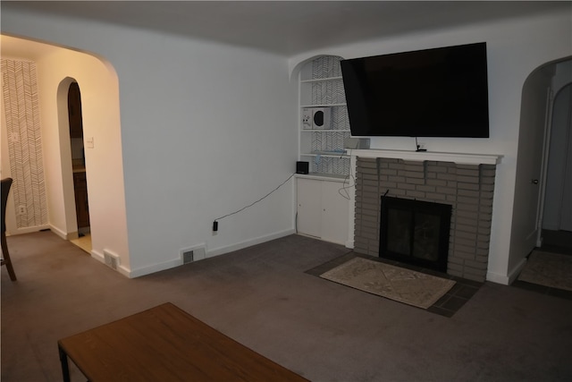 unfurnished living room featuring carpet flooring and a fireplace