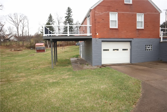 exterior space featuring a wooden deck, a yard, and a garage