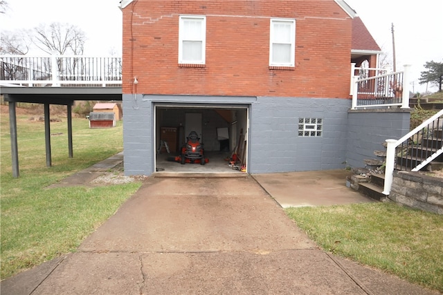 view of side of property featuring a lawn, a garage, and a wooden deck