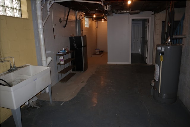 basement featuring stainless steel fridge, sink, and water heater