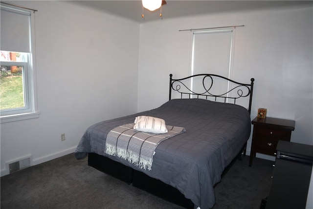 bedroom featuring dark colored carpet