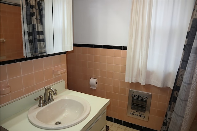 bathroom featuring vanity, tile walls, and heating unit