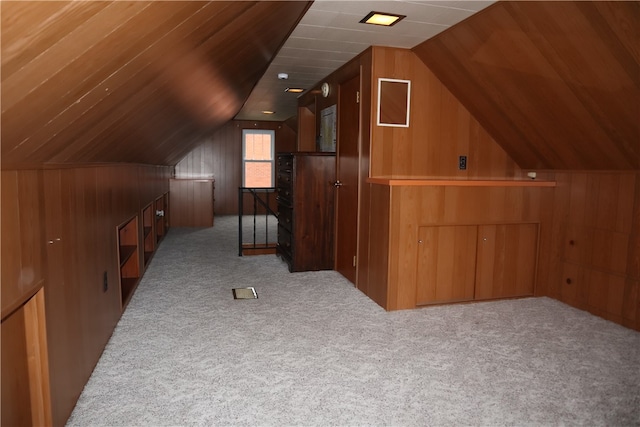 bonus room with light carpet, wooden ceiling, vaulted ceiling, and wooden walls