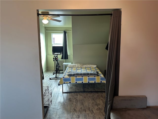 bedroom featuring ceiling fan and wood-type flooring