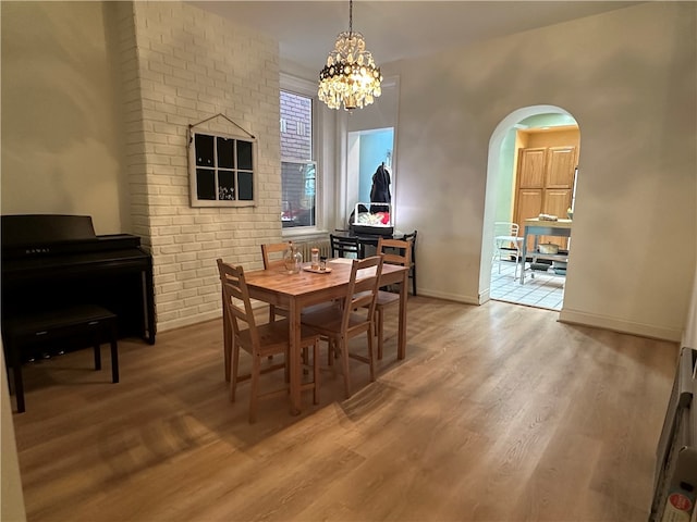 dining room featuring an inviting chandelier and light wood-type flooring