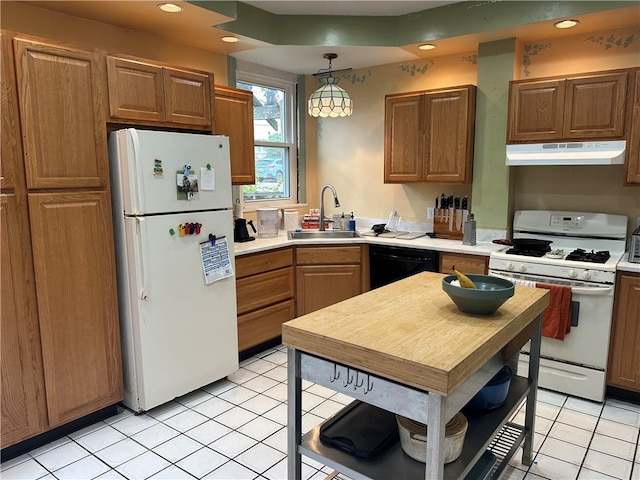 kitchen with light tile patterned flooring, white appliances, sink, and hanging light fixtures