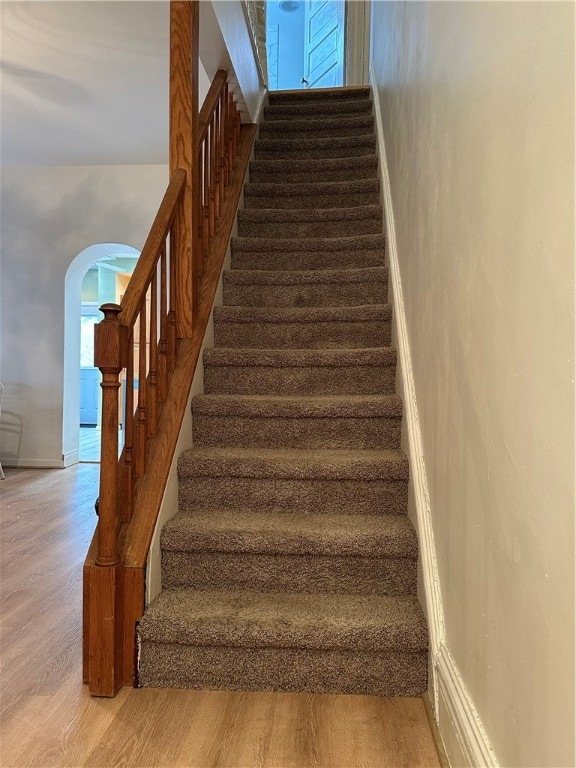 staircase featuring wood-type flooring