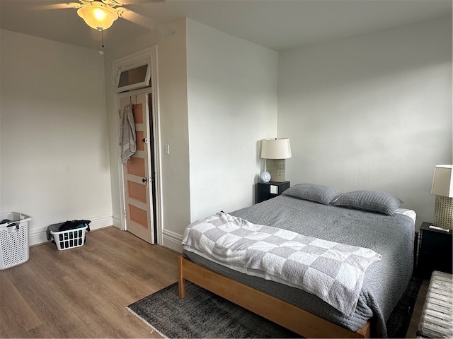 bedroom with ceiling fan and wood-type flooring