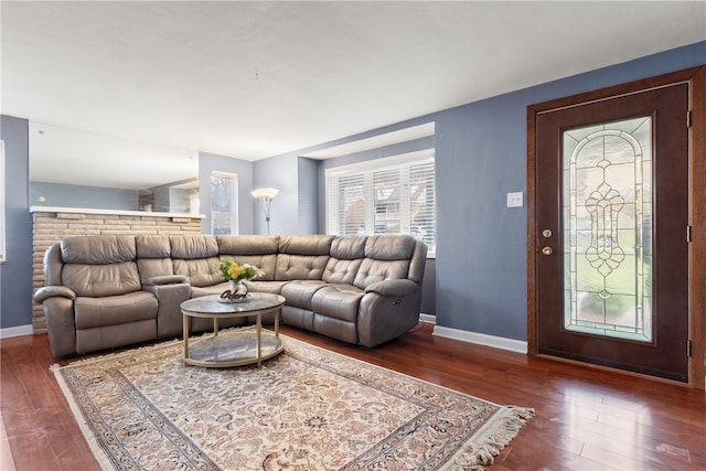 living area featuring baseboards and wood finished floors