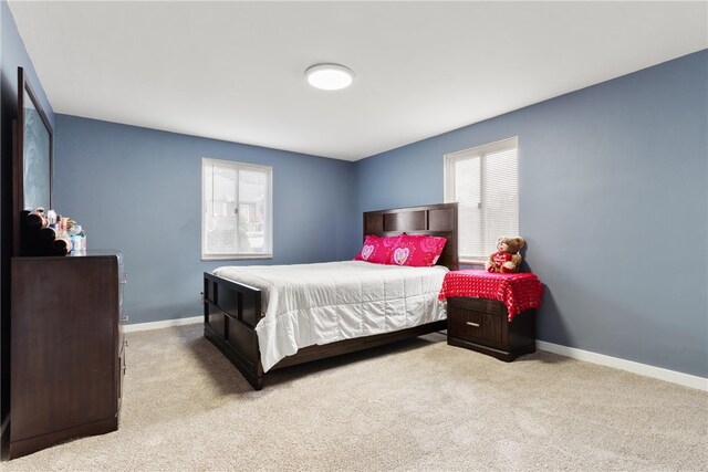 bedroom with baseboards and carpet flooring