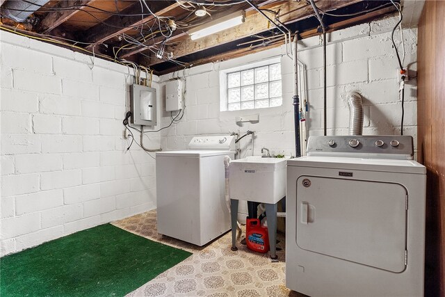 clothes washing area featuring laundry area, washer and clothes dryer, electric panel, and tile patterned floors