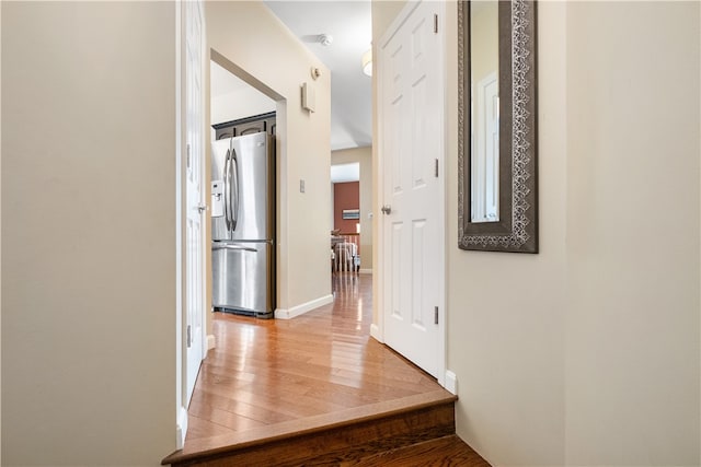 hallway with hardwood / wood-style floors