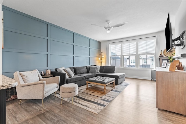 living room featuring hardwood / wood-style flooring and ceiling fan