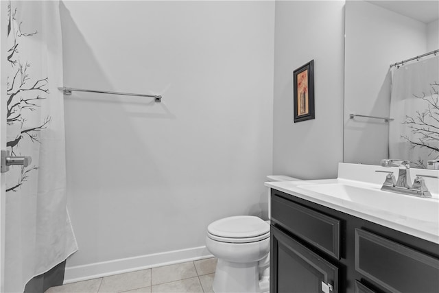 bathroom featuring tile patterned flooring, vanity, curtained shower, and toilet